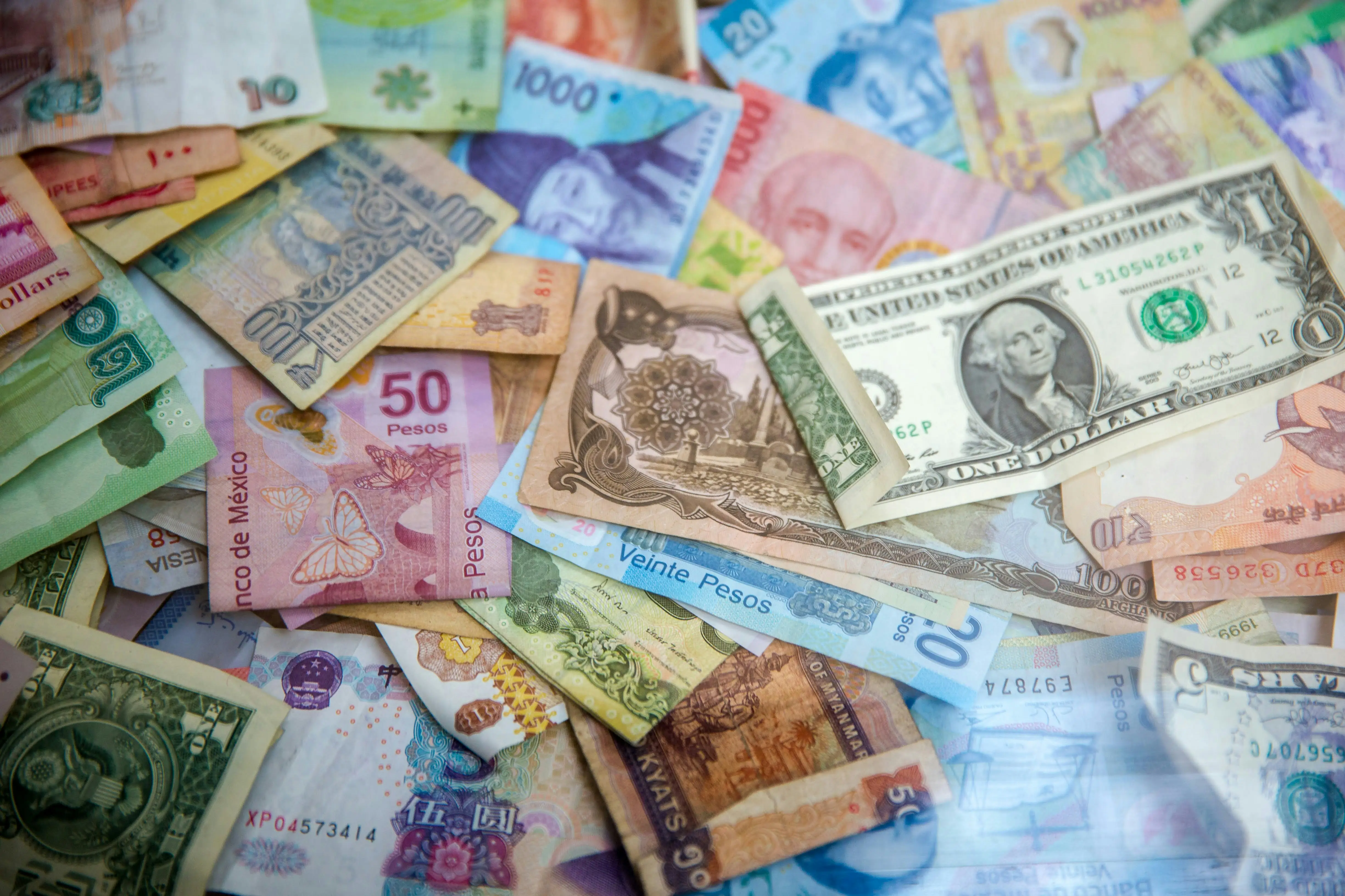 Moroccan Dirham banknotes and coins with traditional market background showing currency exchange and local commerce